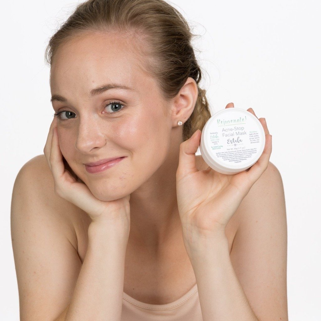 Acne treatment mask by Estala Skincare held by smiling girl