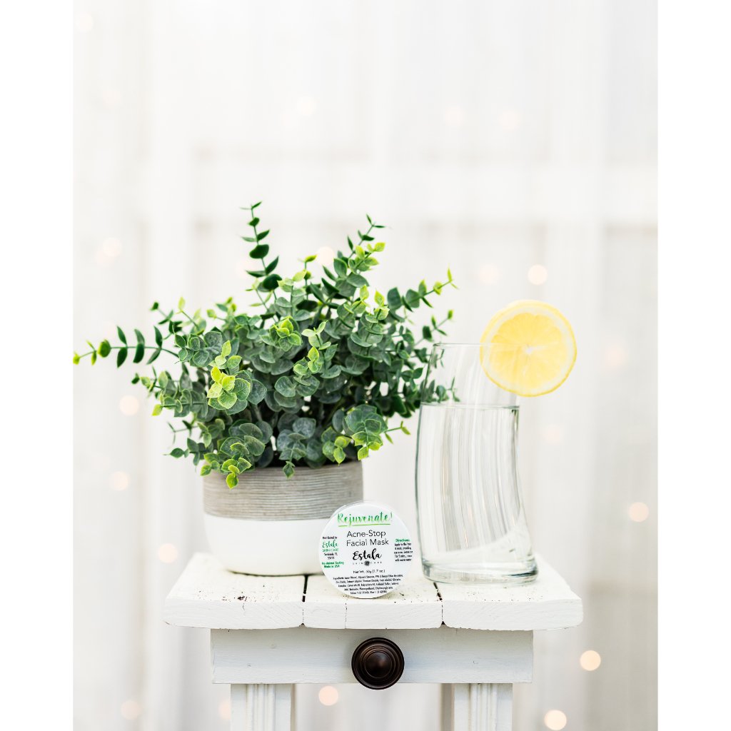 Acne treatment mask by Estala Skincare on elegant picture with a plant and a glass of water
